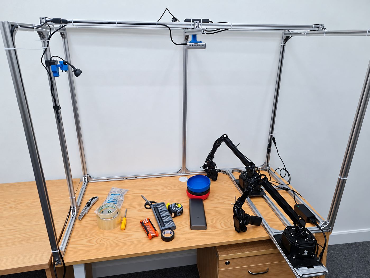 NexArm workspace with the gantry, leader and follower arms, and camera mounts